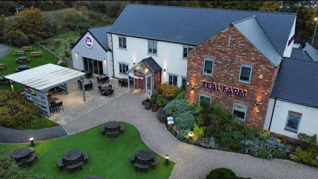 Teal Farm from the air: the pub, the beer garden with picnic benches and the covered seating area