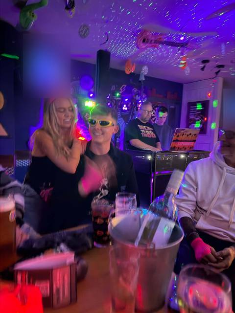 A busy disco night at the Teal Farm bar, with coloured lights and people dancing