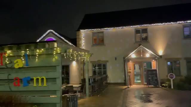 Teal Farm pub at night, with fairy lights along the roof