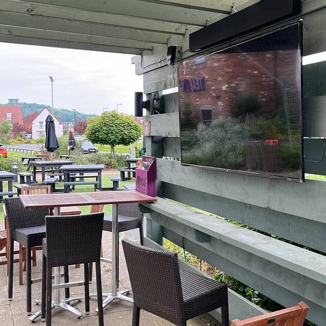 A TV mounted in the covered outdoor area at Teal Farm, switched off